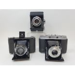 A Zeiss Ikon Ikonta 520/16 folding camera, an Ensign Selfix 16.20 folding camera, and an Agfa