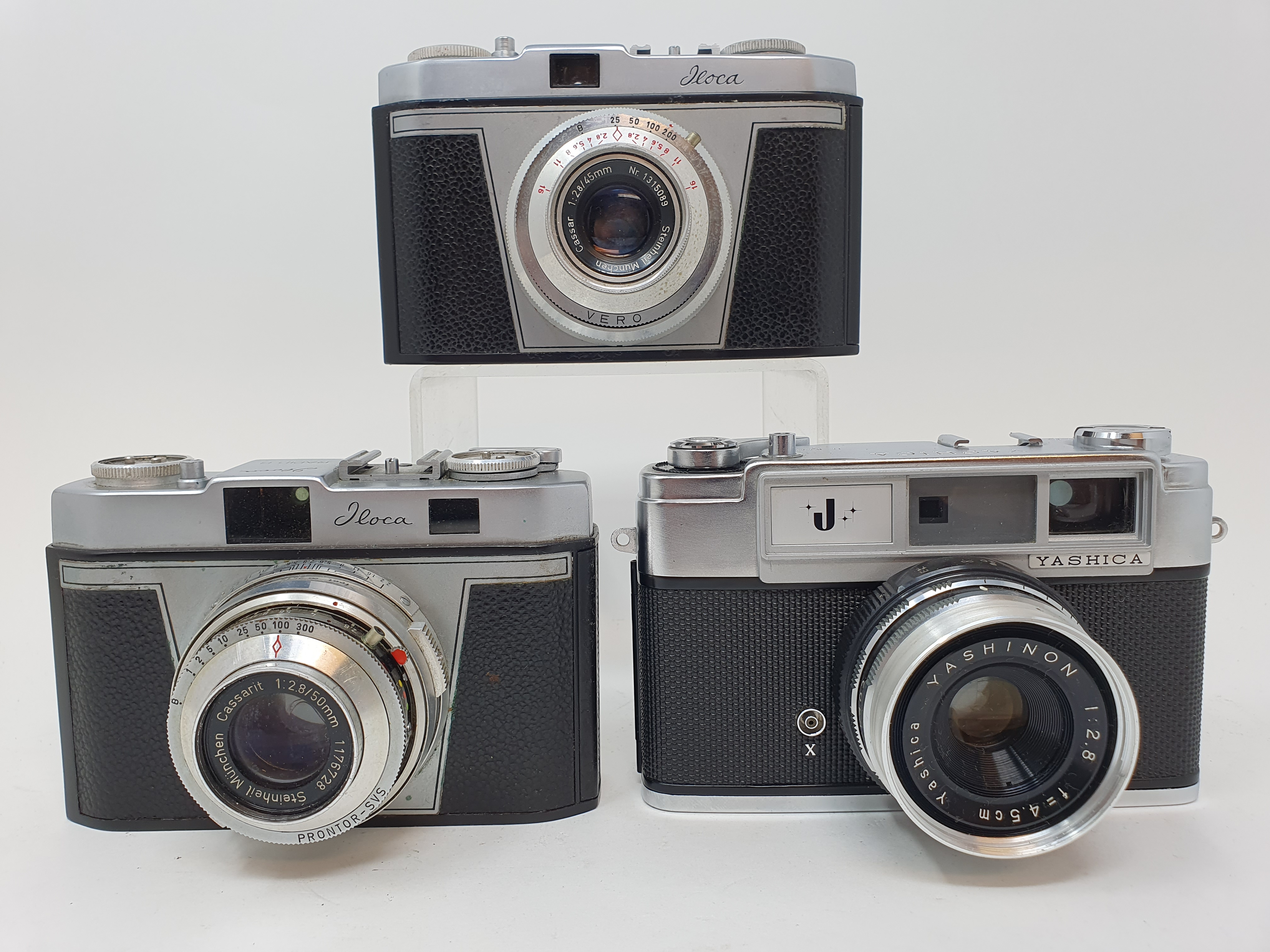 A Yashica camera, an Iloca Rapid-B camera and an Iloca Rapid camera, in outer leather case