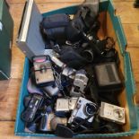 An Olympus iS-1000 camera, a Sony Cybershot, an Olympus Camedia camera, two others, a Fujifilm video