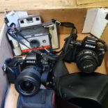 A Land Camera Automatic 220 polaroid camera, with accessories, in camera bag, a Nikon F-801s, with