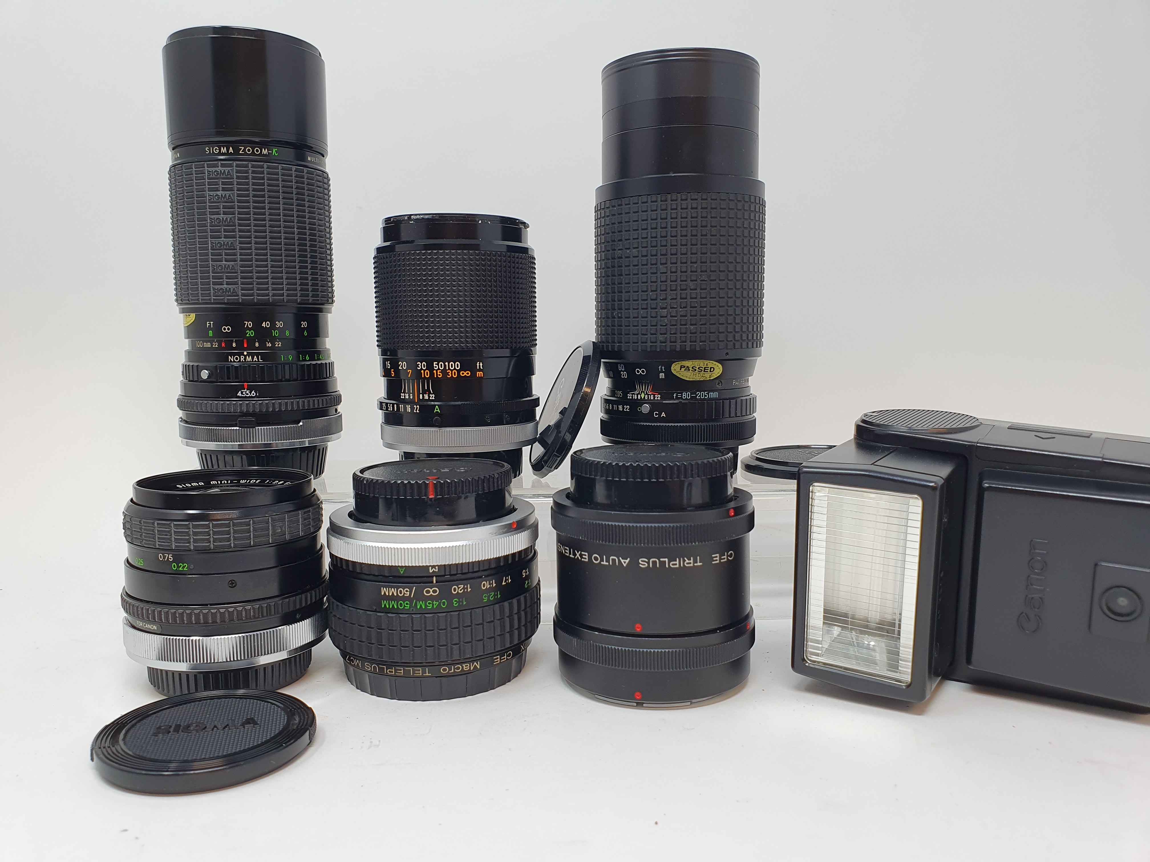 A Sigma camera lens, in outer case, another, three Canon lenses, and a Canon flash, in leather - Image 2 of 10