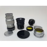 A Leica camera lens, another, a Leica lens cap, a Leitz viewfinder, and two filters (box)