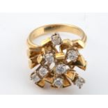 An early 1970s 18ct gold and diamond abstract flower head ring, ring size K