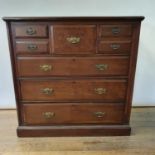 An early 20th century Scottish mahogany chest, having a top hat drawer, flanked by four short