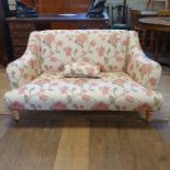 A modern sofa, in floral cream ground fabric, on turned legs, 122 cm wide, and two nests of