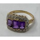 A 9ct gold, three stone emerald cut amethyst and diamond ring Modern