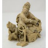 A Japanese carved ivory group, of a lady spinning, with an attendant, Meiji period, 10.5 cm high