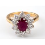 An 18ct gold oval cut ruby and diamond cluster ring, ring size K Ruby 1.50ct, diamonds 1.50ct,