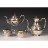 A Chinese silver coloured metal four piece tea set, with bamboo finials, the bodies embossed in high