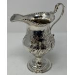 A George III silver jug, of baluster form, decorated flowers and foliage, London 1771, 10.7 ozt,