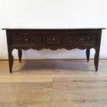 A carved oak serving table, having three frieze drawers, on cabriole legs, 170 cm wide