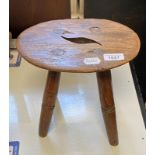 An elm stool, 22 cm high x 26 cm wide Sign of worm