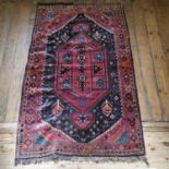 A Persian red ground rug, with multiple borders, centre with steps concentric medallions, 152 x