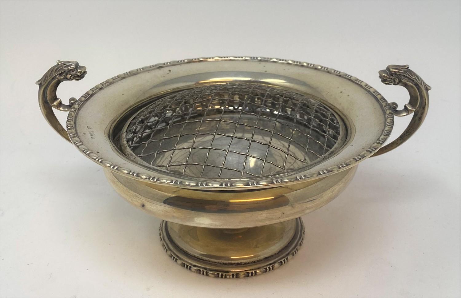 A silver pedestal bowl, inscribed, with dragon handles, Chester 1915, 16.5 ozt, 26 cm wide