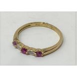 A 9ct gold and five stone ruby and diamond ring, ring size L