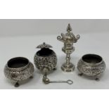 A Burmese style silver coloured metal three piece condiment set, and a Sterling silver pagoda pepper