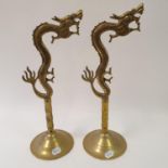 A pair of brass wall light holders, in the form of dragons, 46 cm high (2)