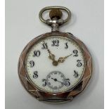 A Continental open face pocket watch, with Arabic numerals and subsidiary seconds dial, in a