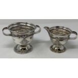 An Irish silver two handle sugar bowl, decorated with a Celtic design, and a matching milk jug,