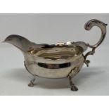 An 18th century silver sauce boat, initialed, on three pad feet, London 1755, 8.1 ozt, 12 cm high