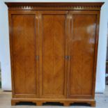 A satinwood triple wardrobe, retail label for S & H Jewell, 187 cm wide x 213 cm high Support
