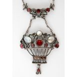 An Art & Crafts style necklace, suspended with a basket