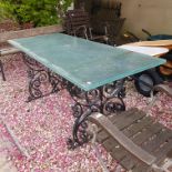 A painted cast iron garden table base, with later glass top, 176 x 74 cm and four folding garden