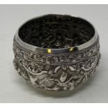 A Burmese silver coloured metal bowl, embossed figures and foliage, 11 cm diameter 7.0 ozt