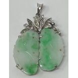 A Carved jade pendent, in the form of a peach, on silver coloured metal and diamond mount,