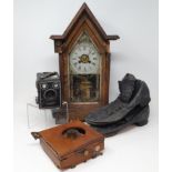 A Kodak brownie box camera, a pair of early 20th century leather boots, an American wall clock,