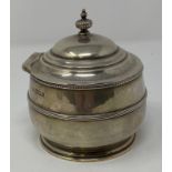 A silver tea caddy and cover, of compressed circular form, London 1918, 7.3 ozt, 10.5 cm high