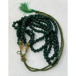 A three strand emerald bead necklace, with adjustable slip knot In excess of 490ct