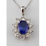 An 18ct white gold, tanzanite and diamond pendant, on a chain