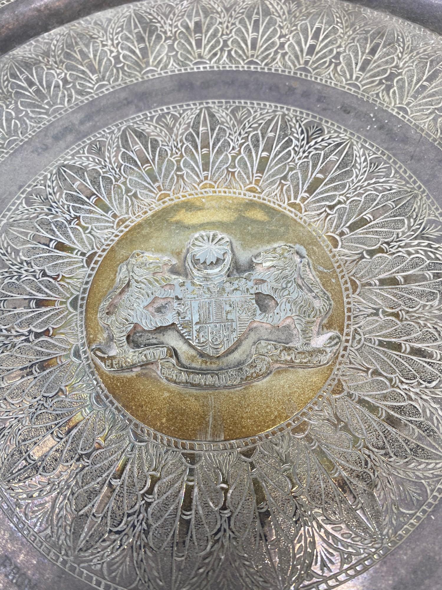 A Malaysian silver coloured metal tray, the centre applied an armorial inscribed with a presentation - Image 3 of 3