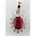 An 18ct gold, oval cut ruby and diamond cluster pendant Ruby 1.25ct, diamonds 0.42ct