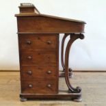 A 19th century walnut Davenport, 56 cm wide Various losses to veneer, leather very worn, needs