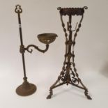A copper and brass oil lamp stand, 56 cm high, and a brass adjustable oil lamp stand, 59 cm high (2)