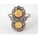 An 18ct gold cabochan opal and diamond cluster ring, ring size P 1/2