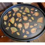A painted oval metal tray, decorated fans, 76 cm wide