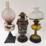 A marbled ceramic lamp, 41 cm high, and two other oil lamps (3)