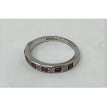 A 18ct white gold ruby and diamond half eternity ring