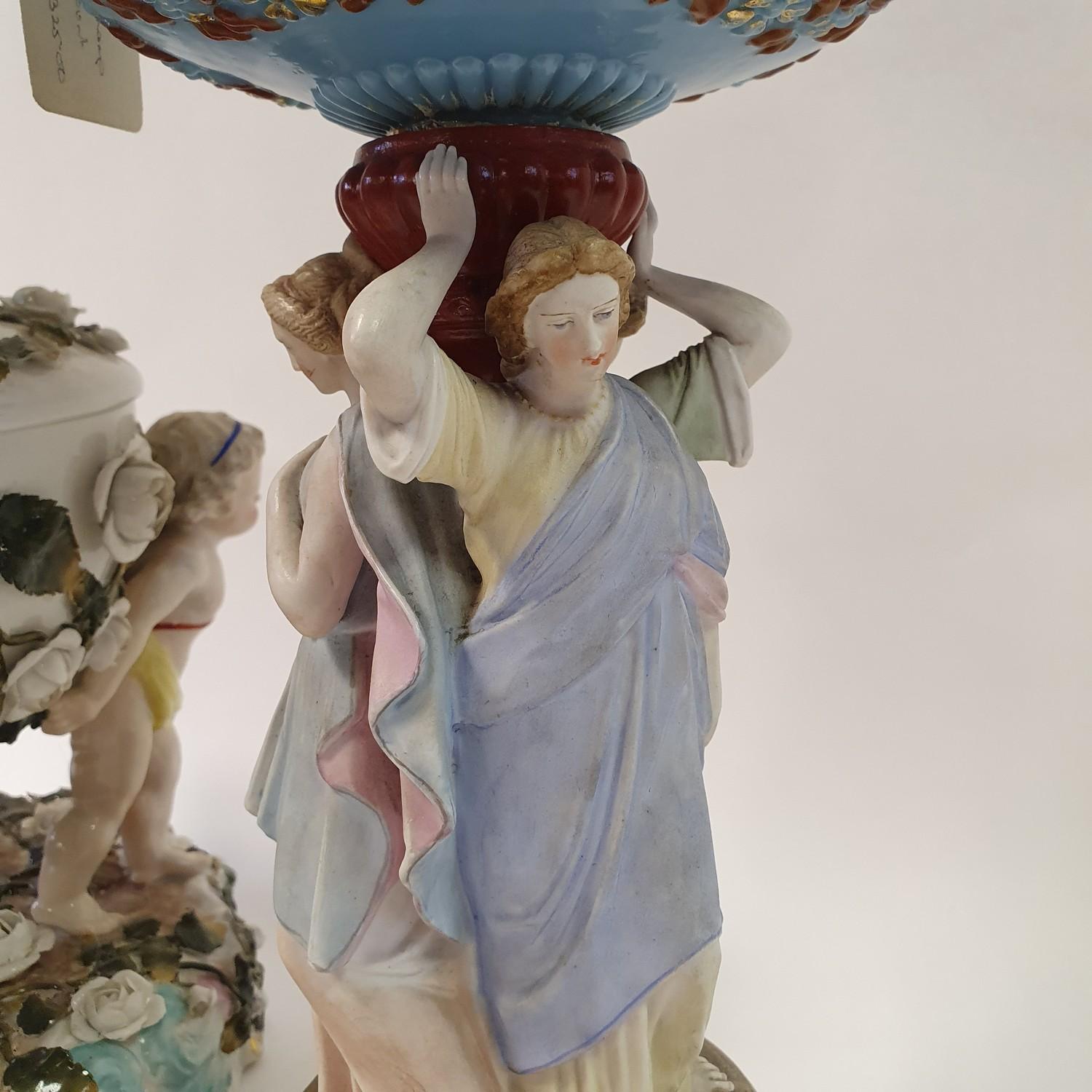 A Dresden porcelain oil lamp, flower encrusted well raised by three putti, 55 cm high, and an oil - Image 3 of 11