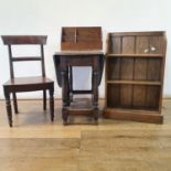 An oak bookcase, 61 cm wide, an oak stationery rack, a dressing mirror, an oak chair and an oak gate