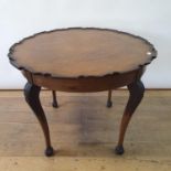 A 19th century mahogany table top, with a pie crust rim, 87 cm diameter, on a later base