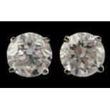 A pair of 14ct white gold and diamond stud earrings, 1.4ct