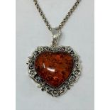 A silver amber heart, on a silver chain Modern