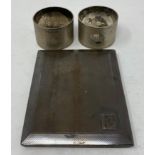 A silver cigarette case, and two silver napkin rings, 7.8 ozt (3)