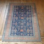 A Persian blue ground rug, main red border, centre with repeating geometric forms, 186 x 138 cm