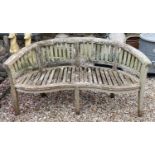 A teak garden bench, 161 cm wide Four of the seat splats are split and weathered