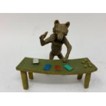 A novelty painted bronze figure, of a croupier at a table, 9 cm high Modern